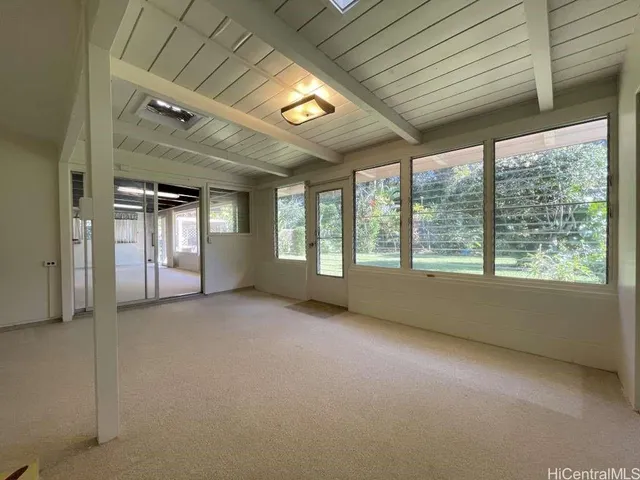 a view of an empty room with large windows