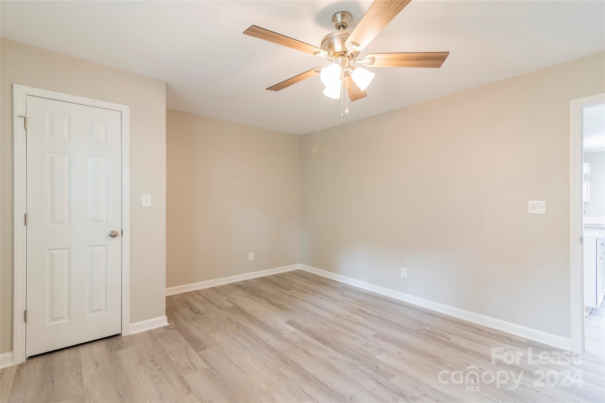 2336 Barry Street, Unit B Charlotte, NC 28205 - Photo 17 of 18 an empty room with wooden floor and fan