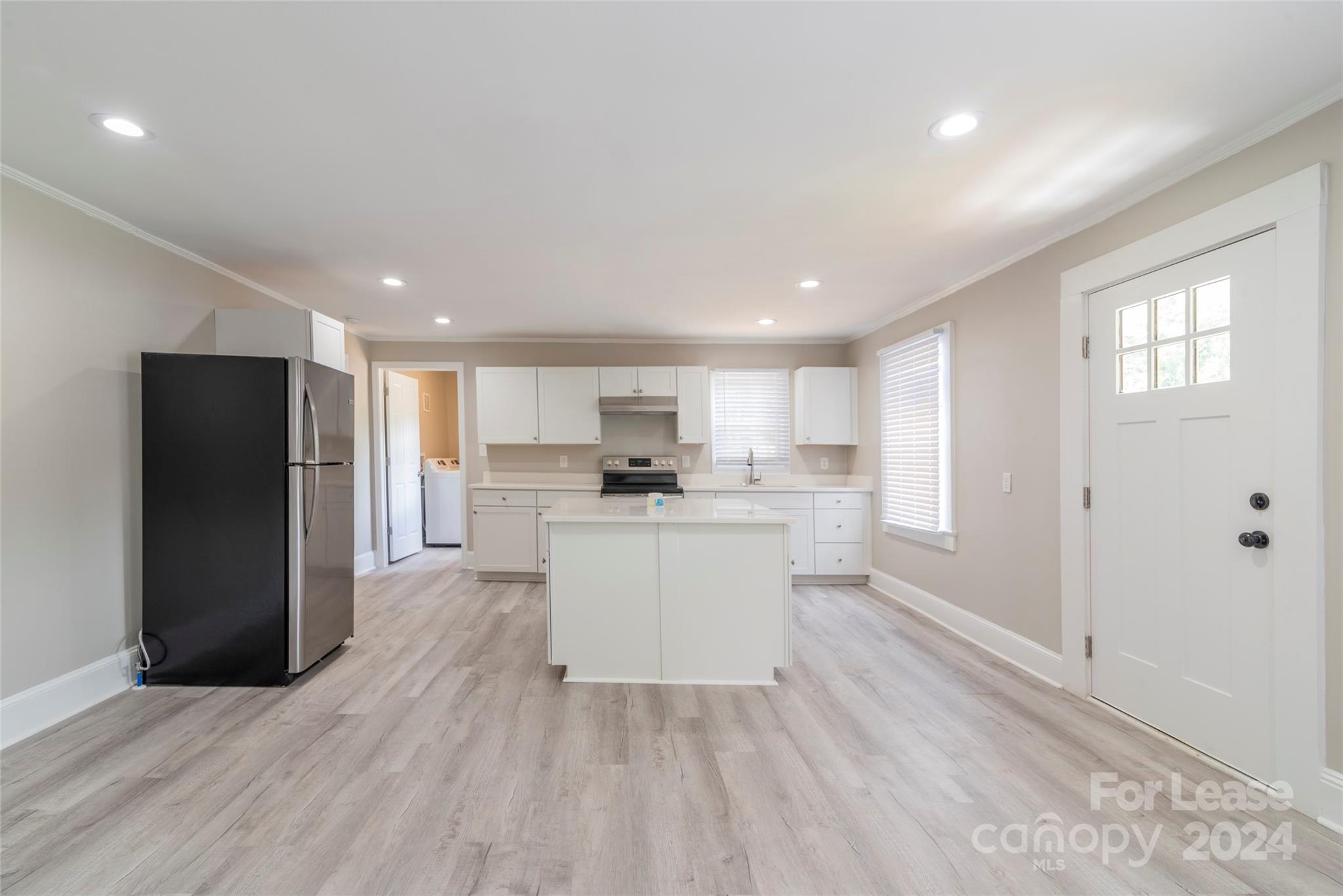 2336 Barry Street, Unit B Charlotte, NC 28205 - Photo 3 of 18 a kitchen with a refrigerator and white cabinets