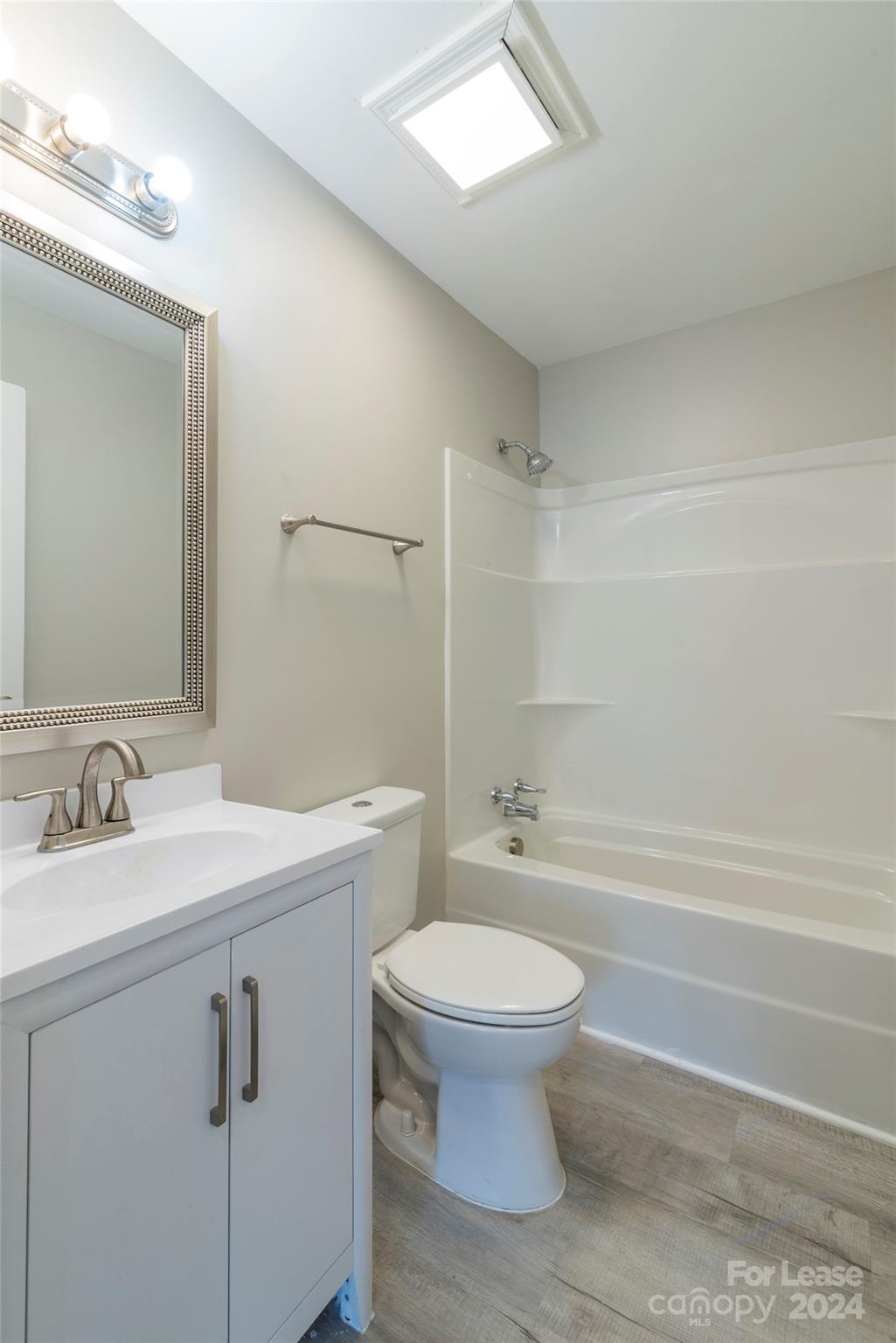 2336 Barry Street, Unit B Charlotte, NC 28205 - Photo 9 of 18 a bathroom with a sink toilet vanity and tub