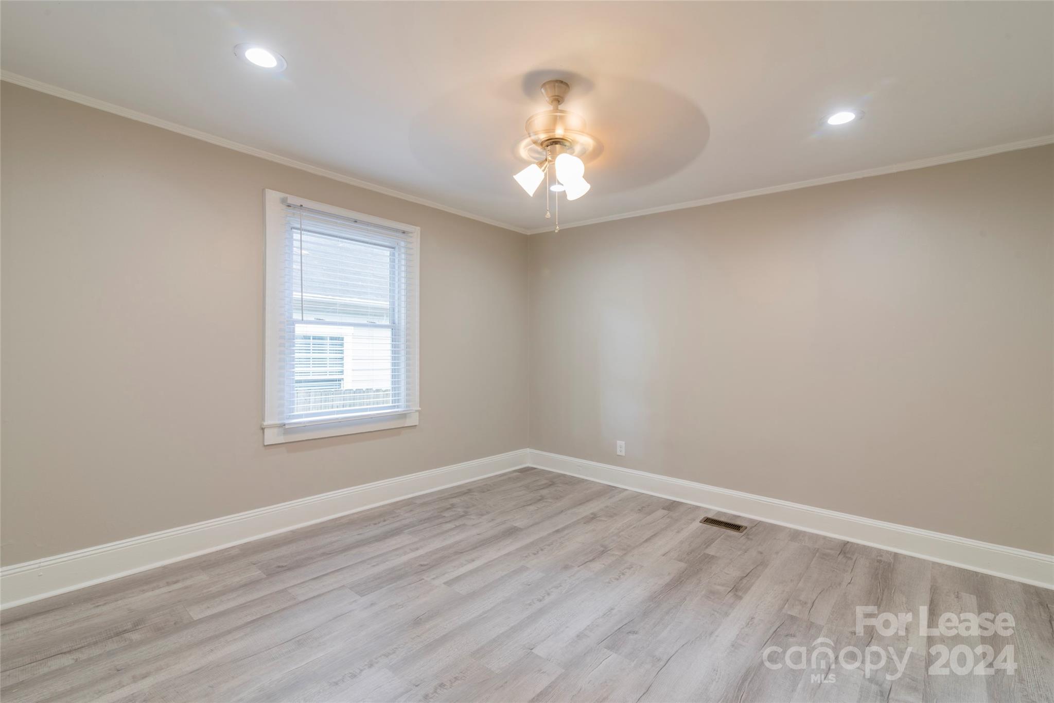 2336 Barry Street, Unit B Charlotte, NC 28205 - Photo 10 of 18 an empty room with wooden floor and windows