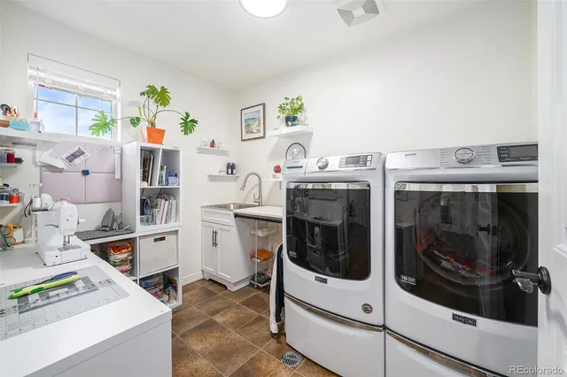 a utility room with multiple dryer and washer