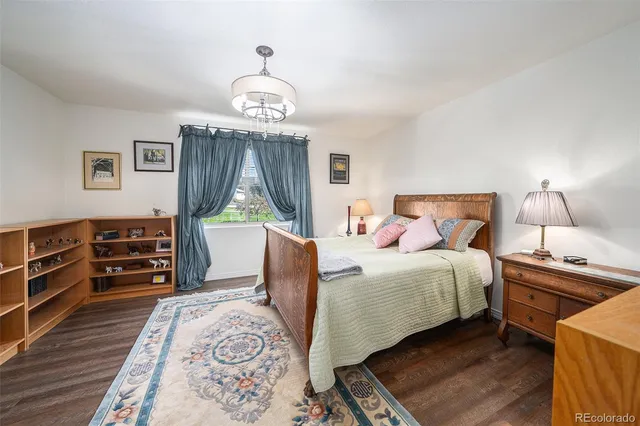 a bedroom with bed and wooden floor