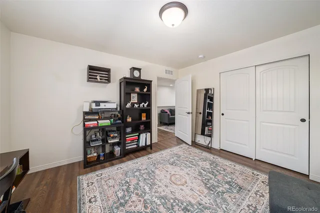 a view of a workspace with furniture and wooden floor