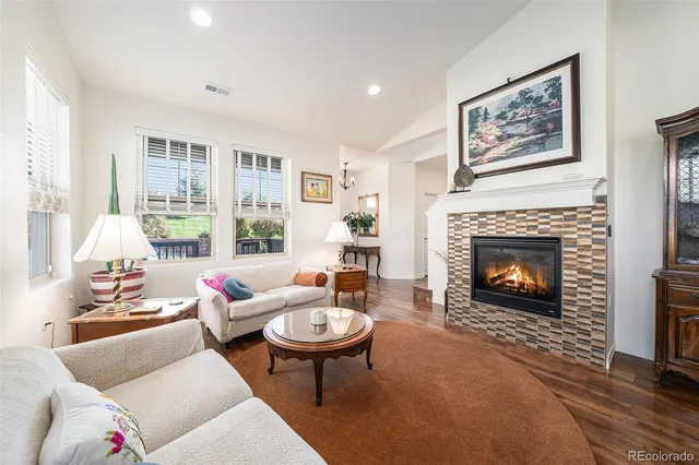 a living room with furniture a table and a fireplace