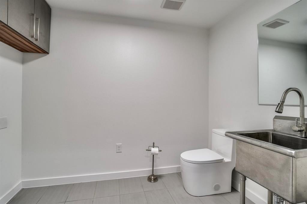 1408 South Alamo Road Rockwall, TX 75087 - Photo 35 of 40 a bathroom with a toilet and sink