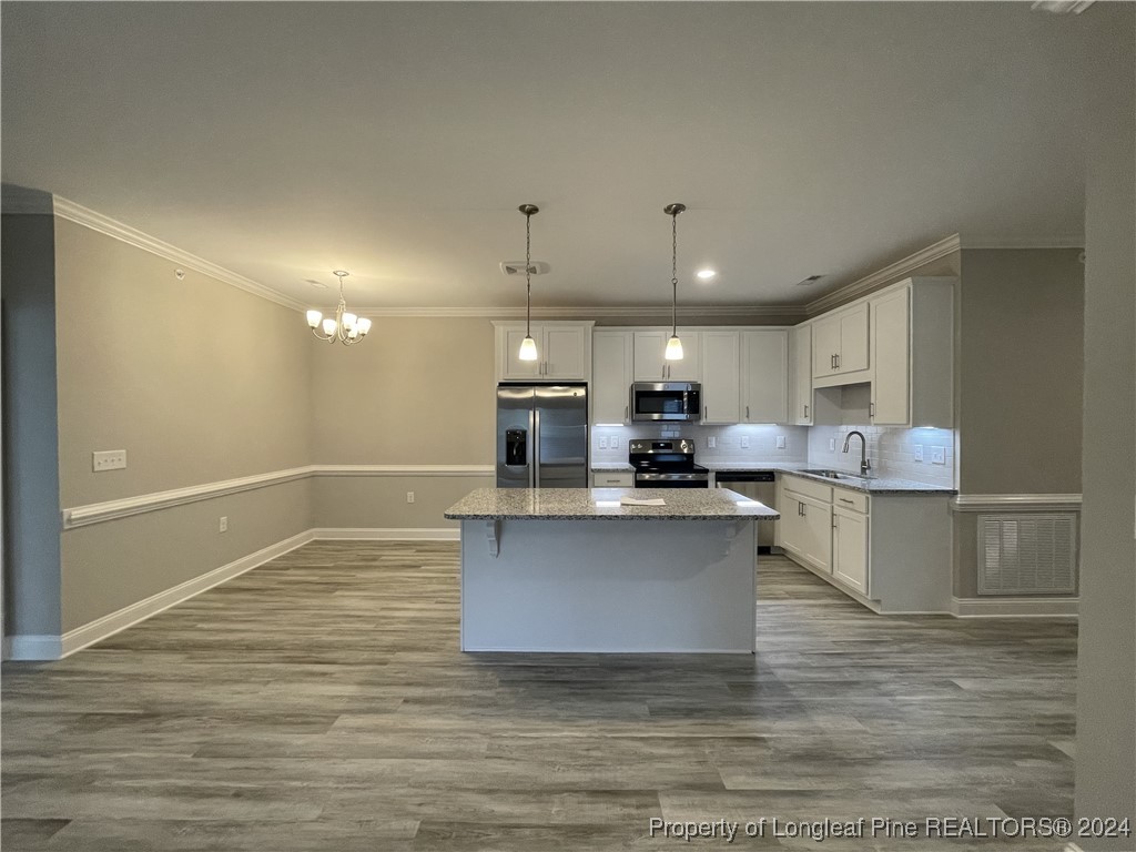 240 Gallery Drive, Unit 304 Spring Lake, NC 28390 - Photo 4 of 16 a kitchen with stainless steel appliances granite countertop a sink cabinets and wooden floor