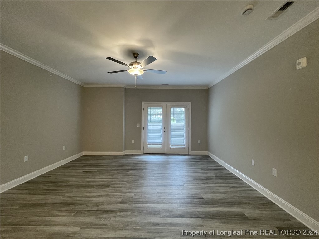 240 Gallery Drive, Unit 304 Spring Lake, NC 28390 - Photo 6 of 16 a view of an empty room with a window and wooden floor