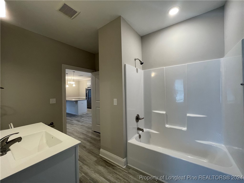 240 Gallery Drive, Unit 304 Spring Lake, NC 28390 - Photo 8 of 16 a bathroom with a sink a shower and a mirror