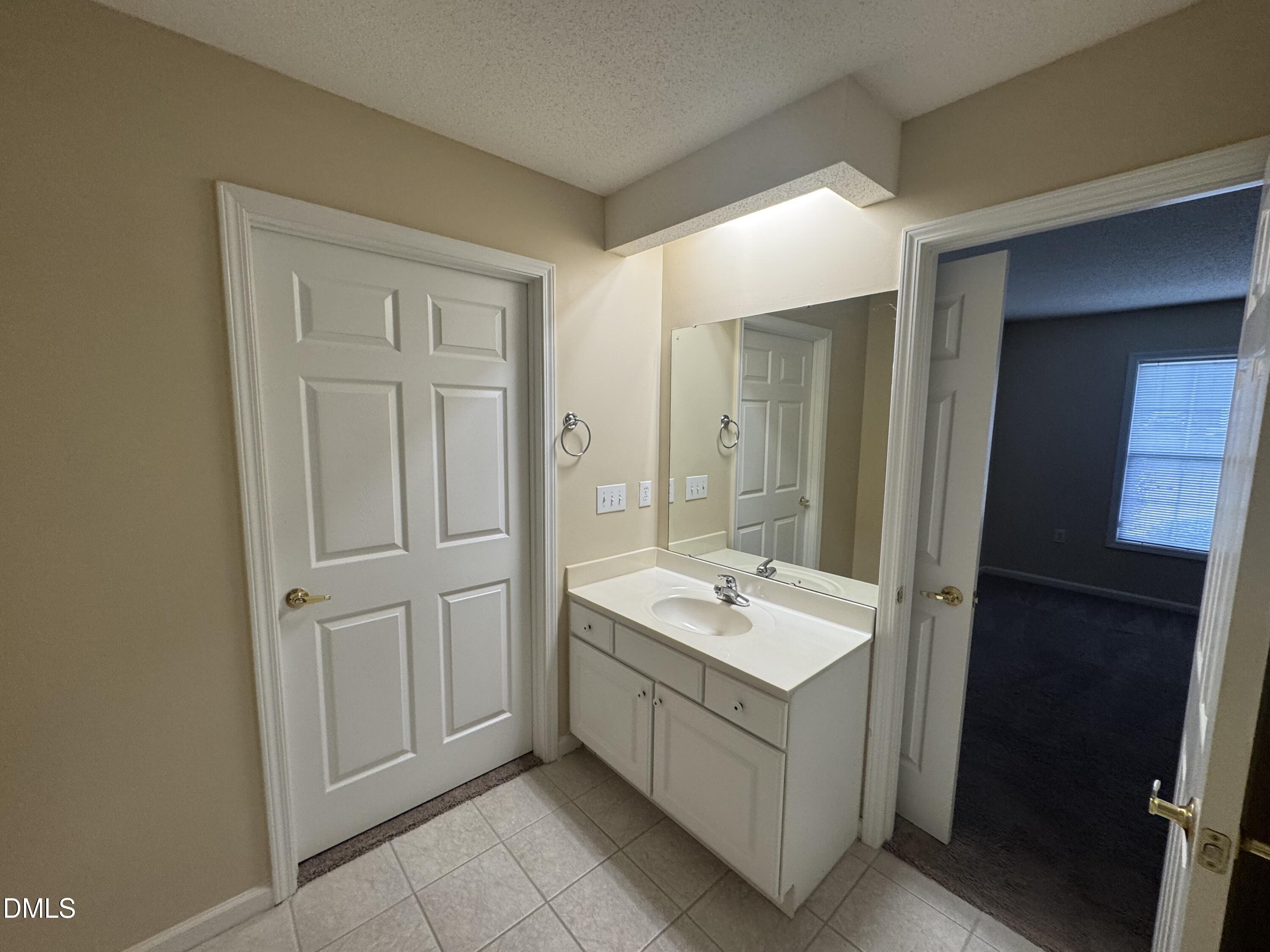 Undisclosed Address Raleigh, NC 27617 - Photo 8 of 22 a bathroom with a sink and a mirror