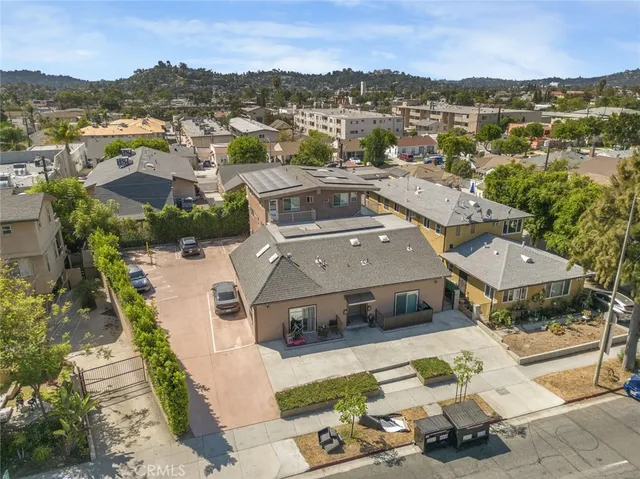 an aerial view of residential houses with outdoor space