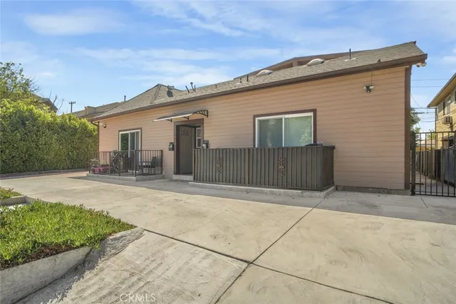 a backyard of a house with yard and outdoor seating