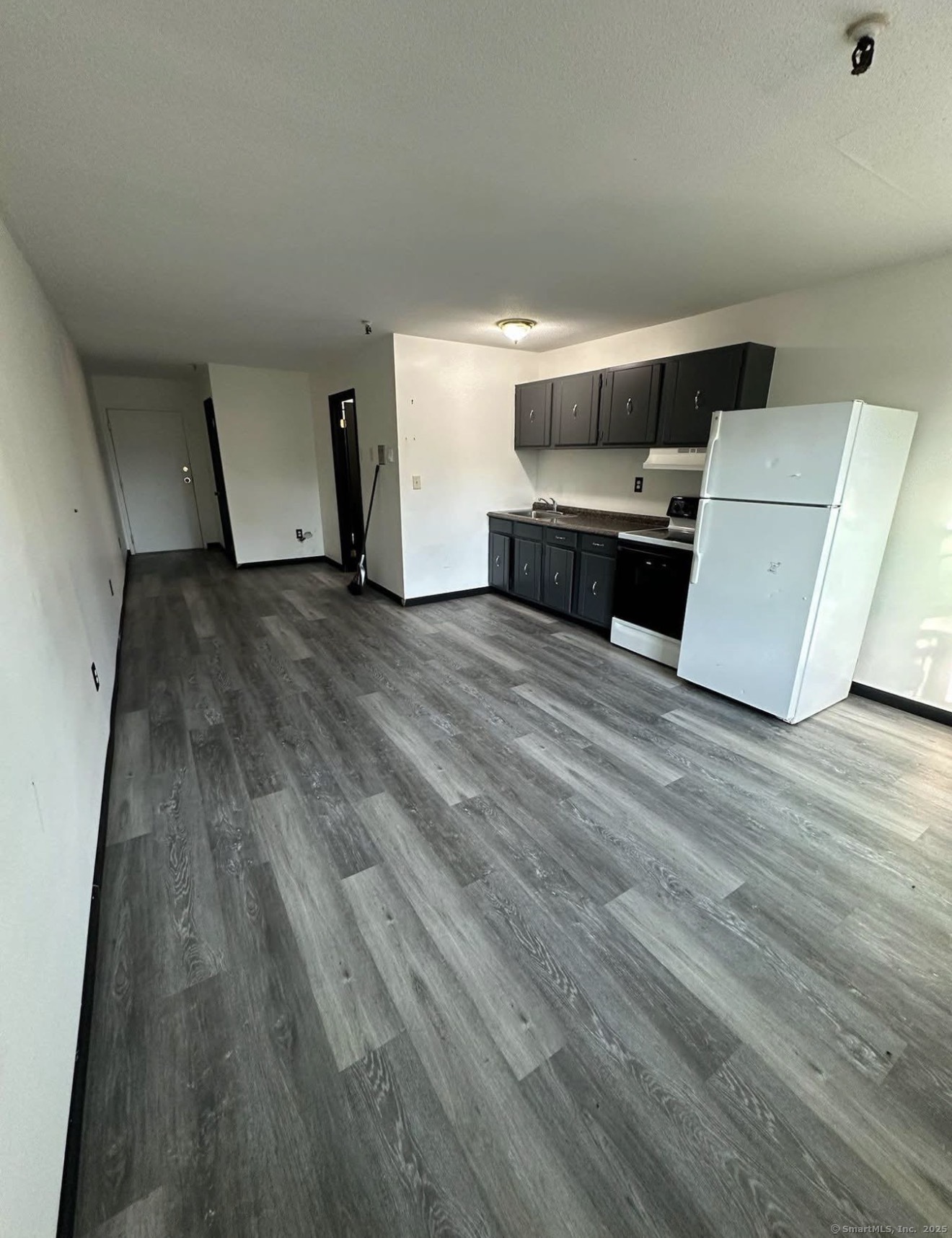 a view of kitchen and wooden floor