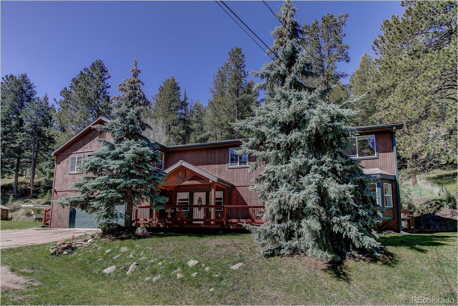 4961 Little Cub Creek Road Evergreen, CO 80439 - Photo 1 of 38 a view of a house with a yard and tree s
