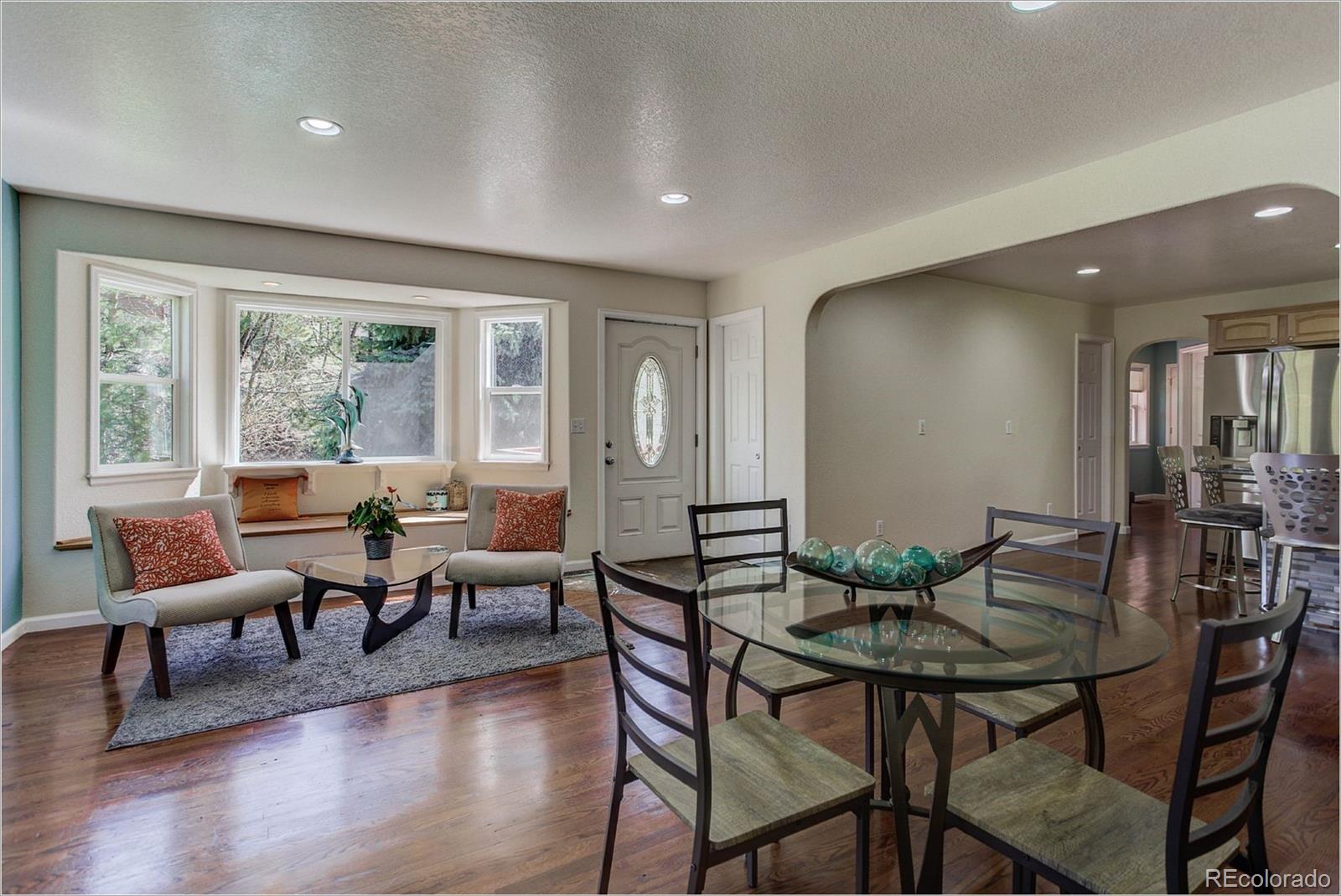 4961 Little Cub Creek Road Evergreen, CO 80439 - Photo 14 of 38 a view of a dining room with furniture window and wooden floor