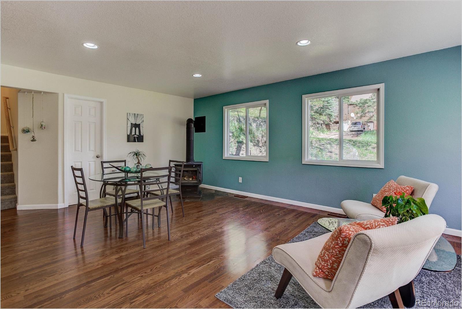 4961 Little Cub Creek Road Evergreen, CO 80439 - Photo 15 of 38 a living room with furniture and a wooden floor