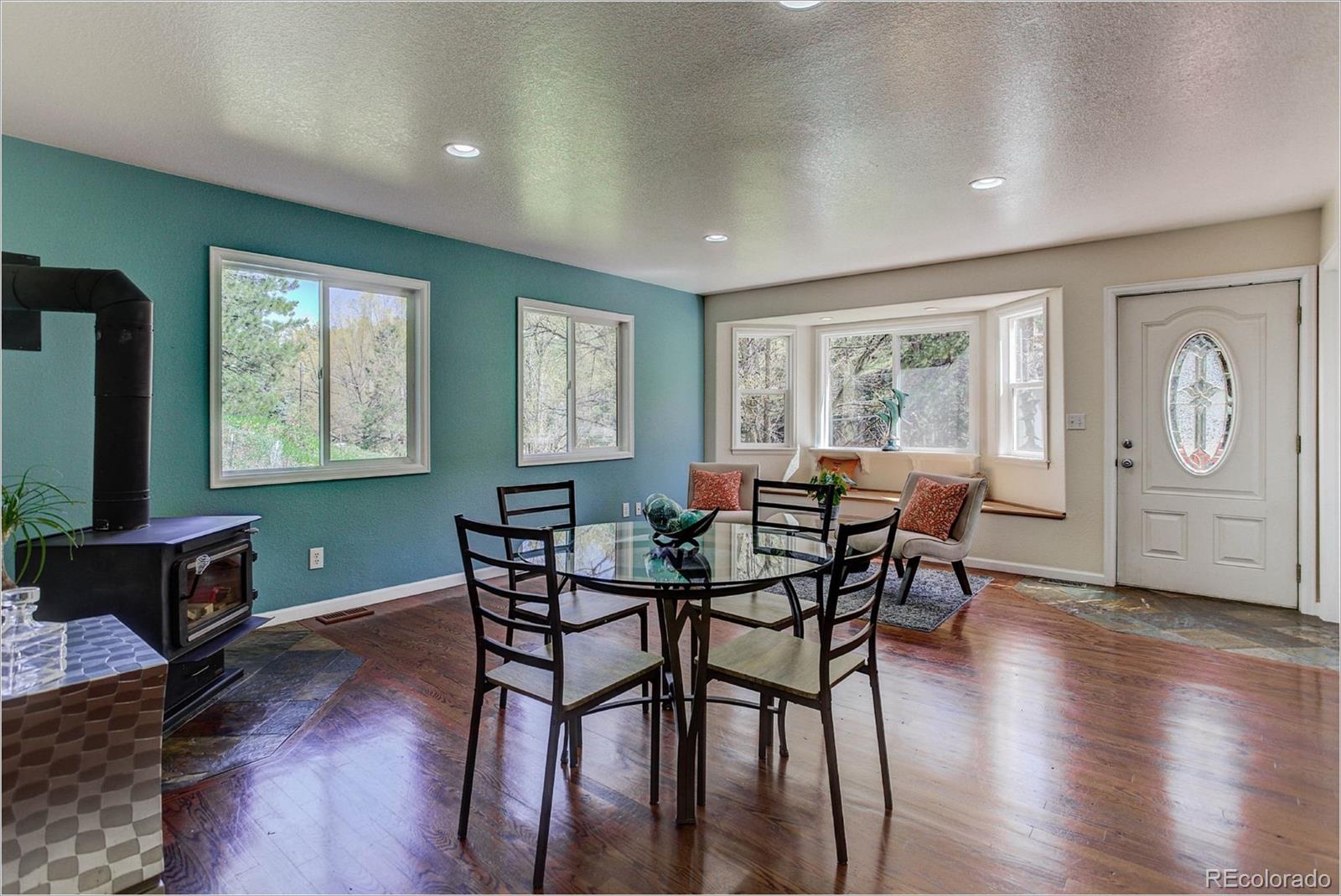 4961 Little Cub Creek Road Evergreen, CO 80439 - Photo 16 of 38 a view of a dining room with furniture window and wooden floor