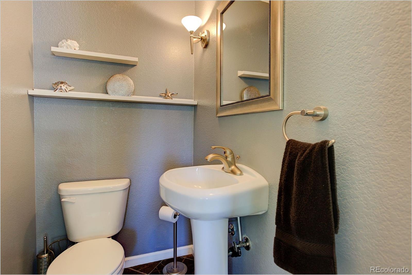 4961 Little Cub Creek Road Evergreen, CO 80439 - Photo 17 of 38 a bathroom with a toilet sink and mirror