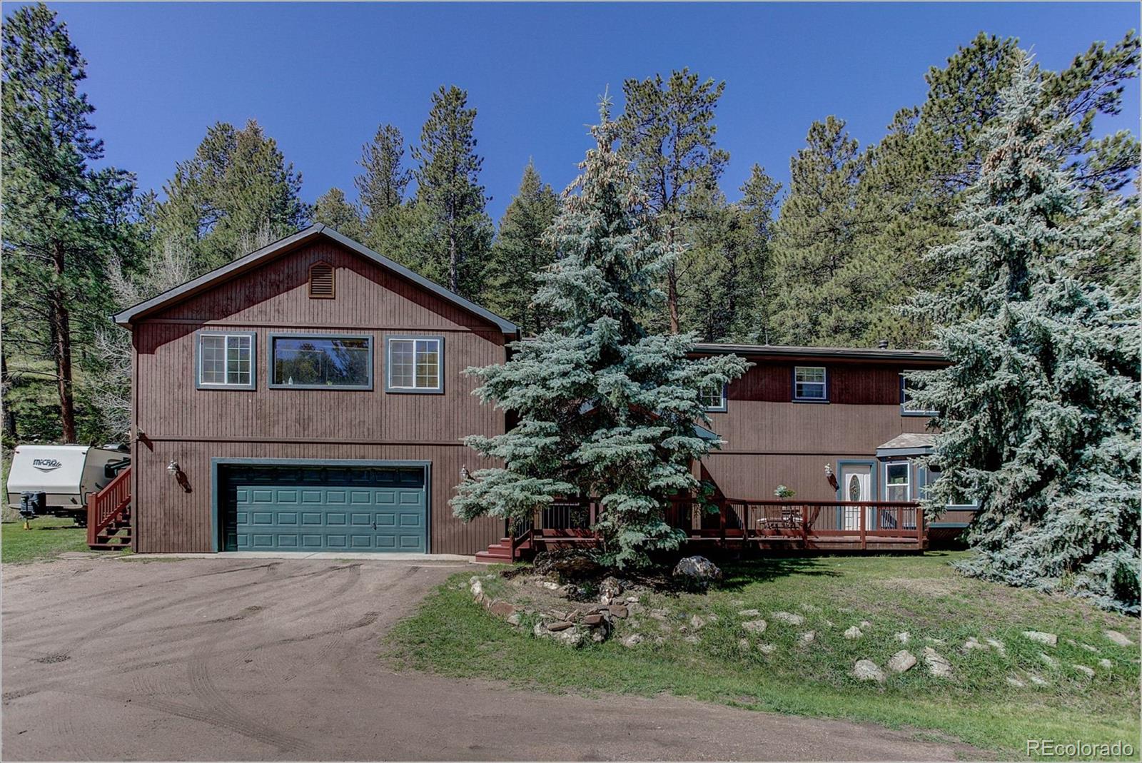 4961 Little Cub Creek Road Evergreen, CO 80439 - Photo 2 of 38 a view of a house with a yard and potted plants