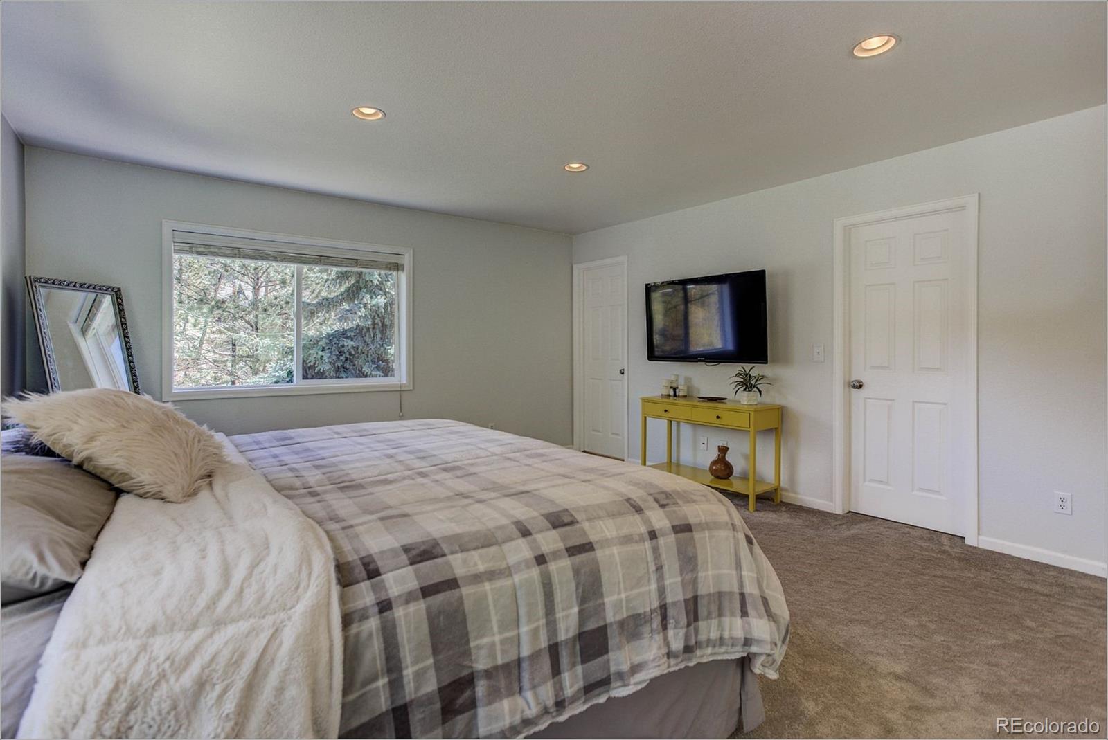 4961 Little Cub Creek Road Evergreen, CO 80439 - Photo 21 of 38 a bedroom with a bed and a tv