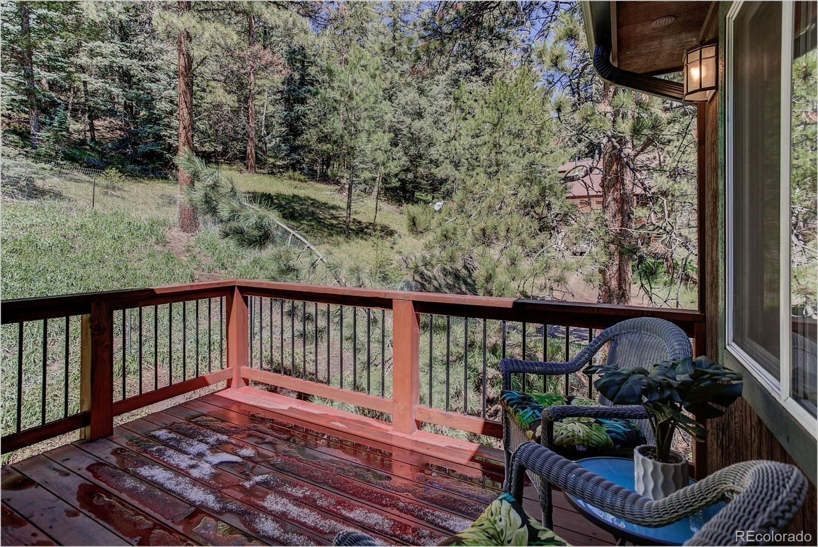 4961 Little Cub Creek Road Evergreen, CO 80439 - Photo 23 of 38 a view of balcony with wooden floor and outdoor seating