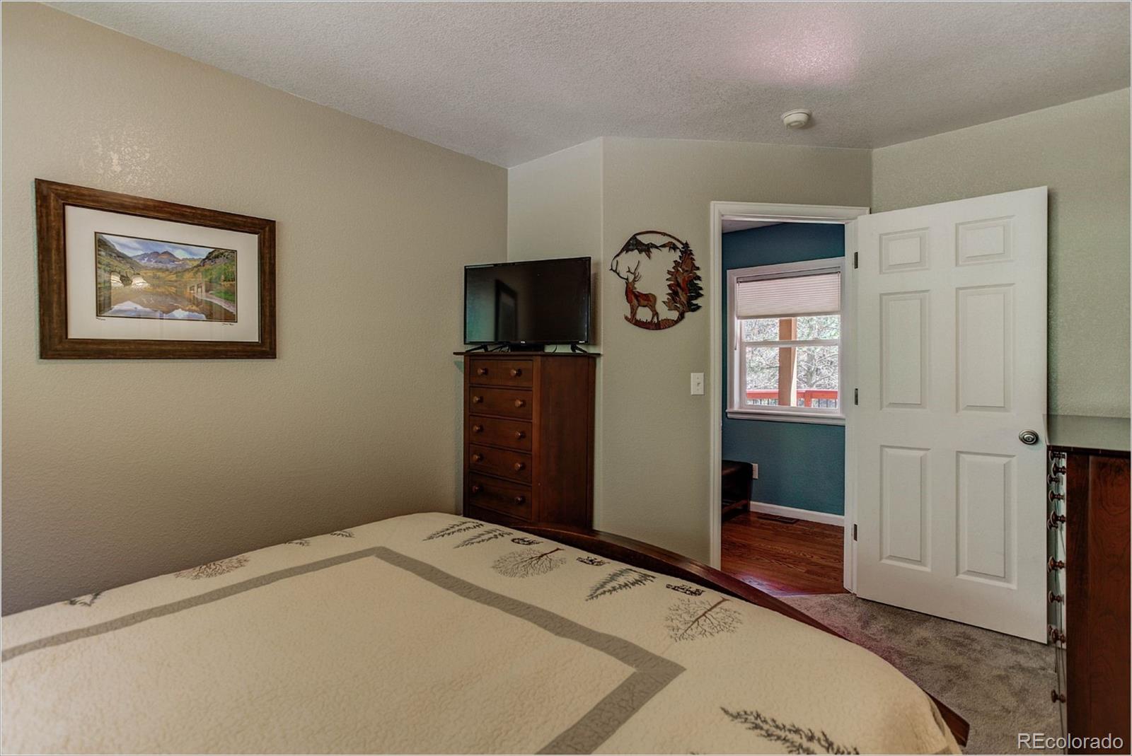 4961 Little Cub Creek Road Evergreen, CO 80439 - Photo 24 of 38 a bedroom with a bed and a window