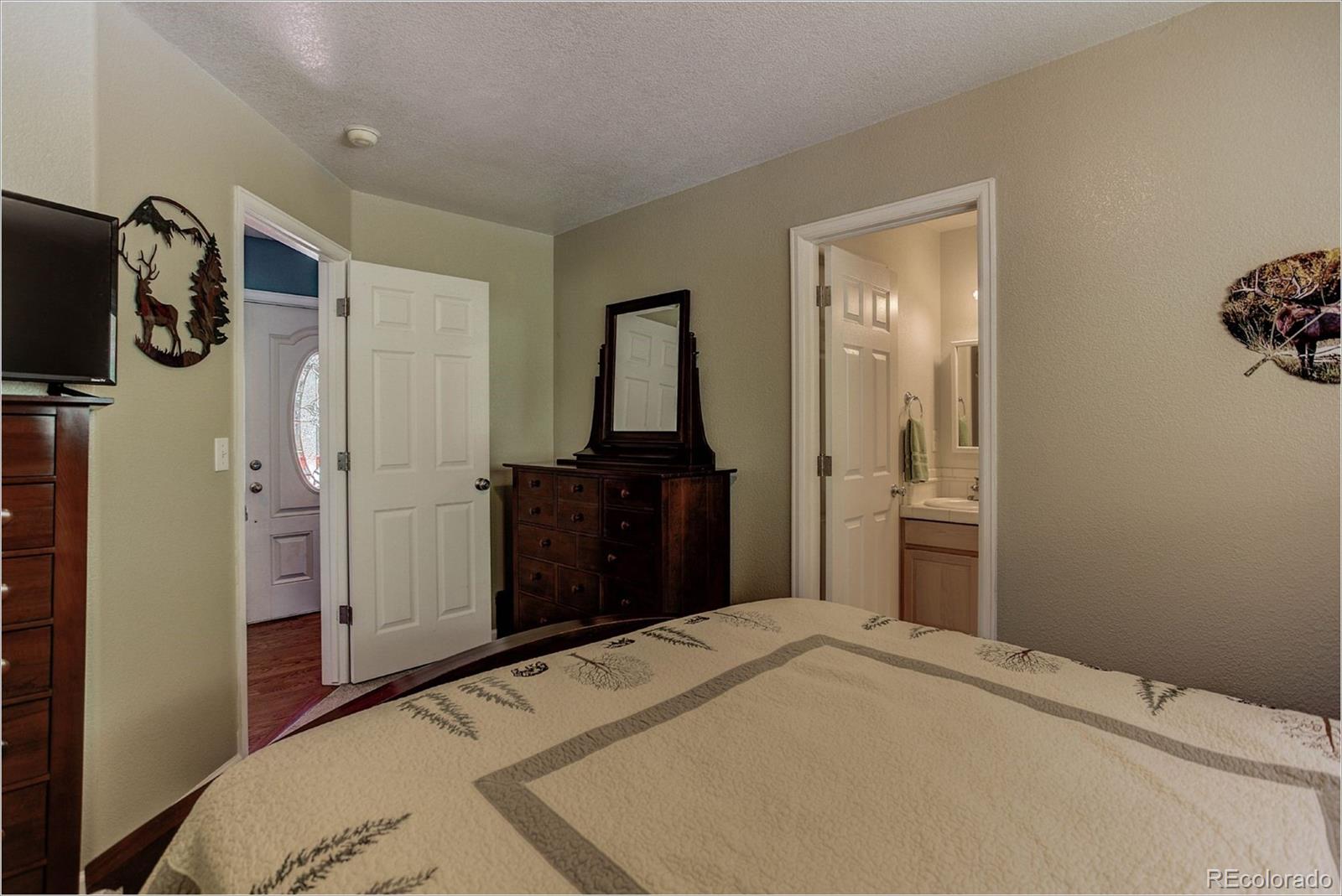 4961 Little Cub Creek Road Evergreen, CO 80439 - Photo 25 of 38 a bedroom with a bed and a mirror