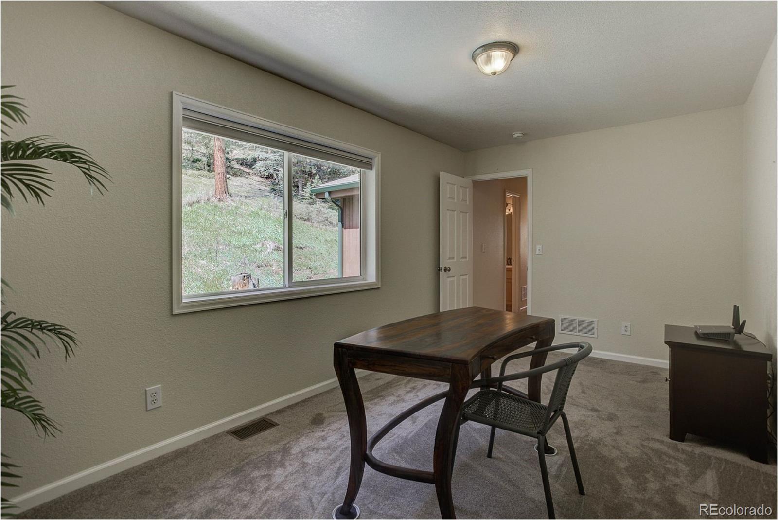 4961 Little Cub Creek Road Evergreen, CO 80439 - Photo 29 of 38 a dining room with furniture and window