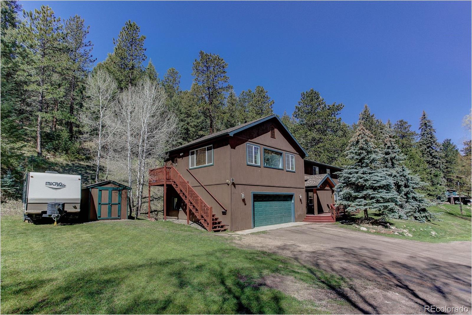 4961 Little Cub Creek Road Evergreen, CO 80439 - Photo 6 of 38 a house view with a garden space