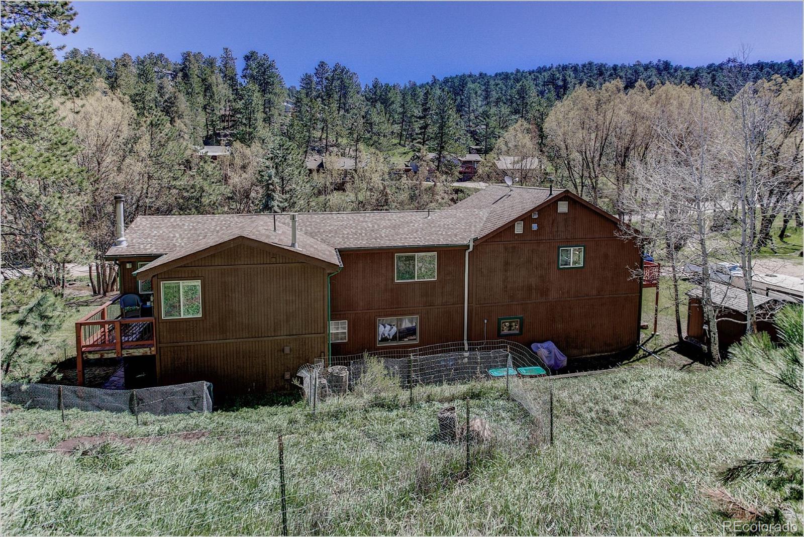4961 Little Cub Creek Road Evergreen, CO 80439 - Photo 7 of 38 a front view of a house with a yard