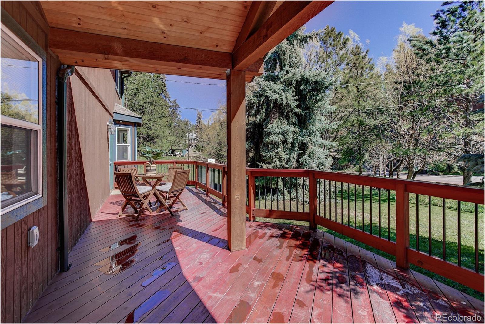 4961 Little Cub Creek Road Evergreen, CO 80439 - Photo 8 of 38 a view of a two chairs in the balcony
