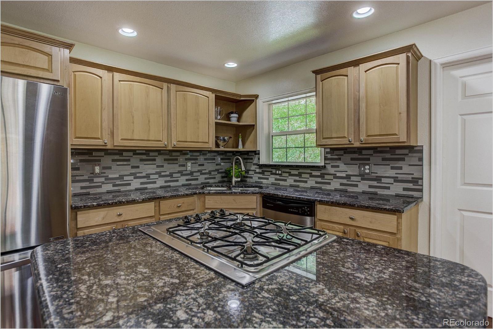 4961 Little Cub Creek Road Evergreen, CO 80439 - Photo 9 of 38 a kitchen with a stove a sink and a refrigerator
