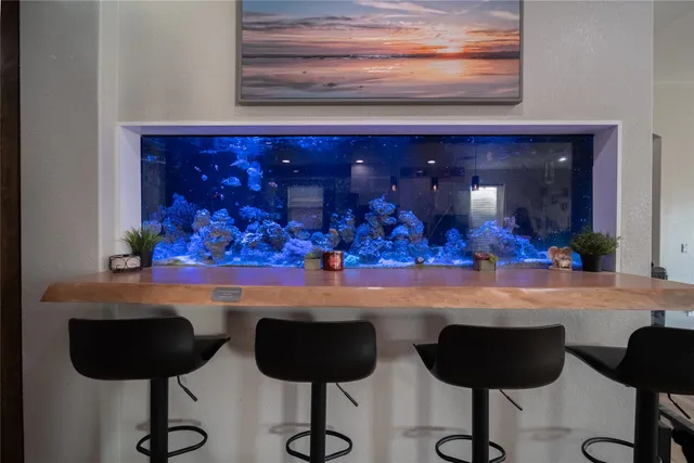 a room with wooden floor and pool table