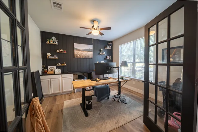 a bedroom with a bed and a large window
