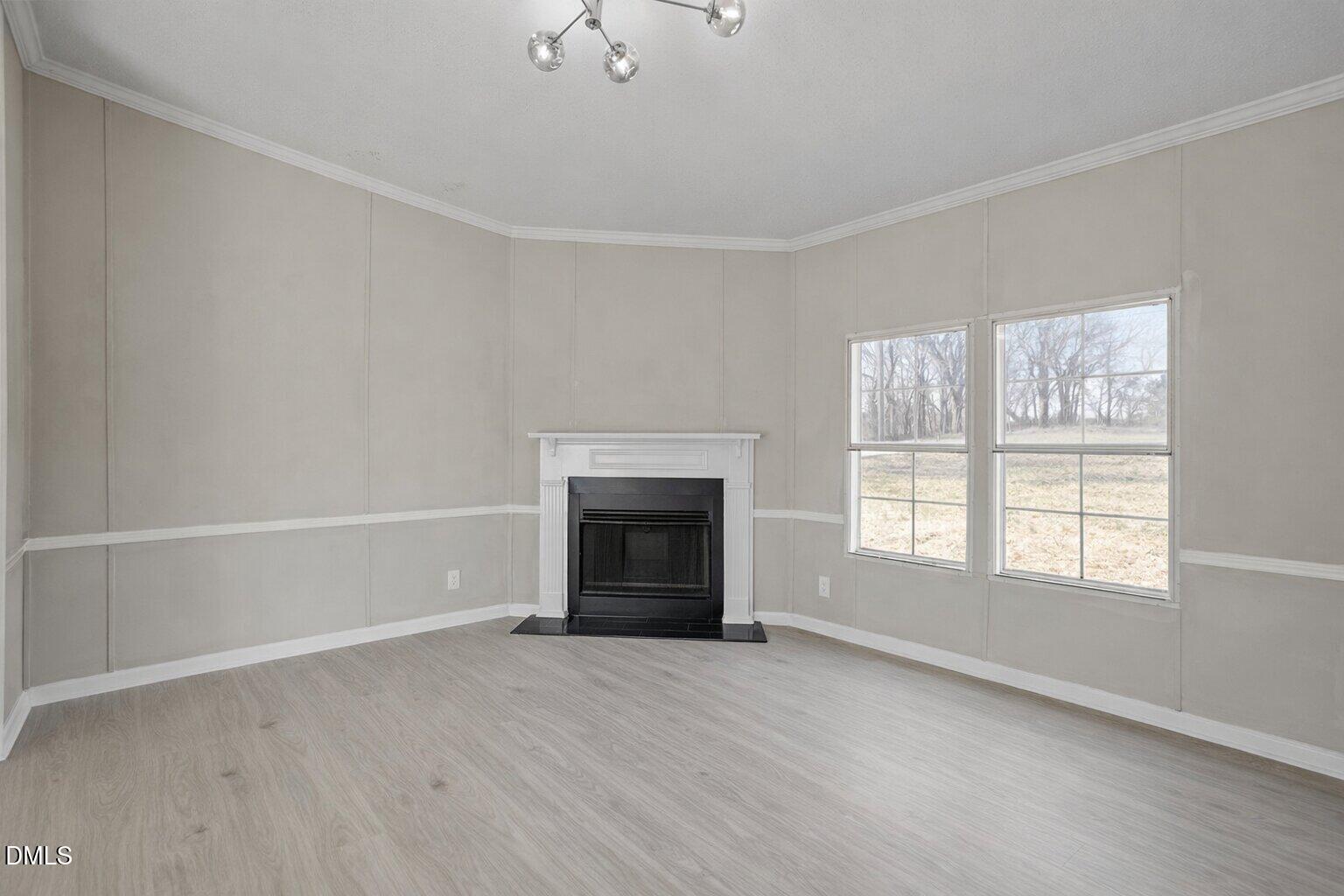 10965 Beaver Dam Road Middlesex, NC 27557 - Photo 12 of 24 an empty room with windows and fireplace