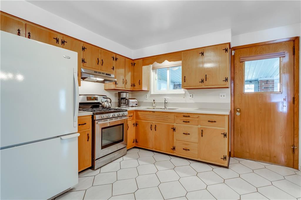 207 Erwin Place McKees Rocks, PA 15136 - Photo 8 of 25 Ceramic tile floors, window overlooks and door leads to sun room.