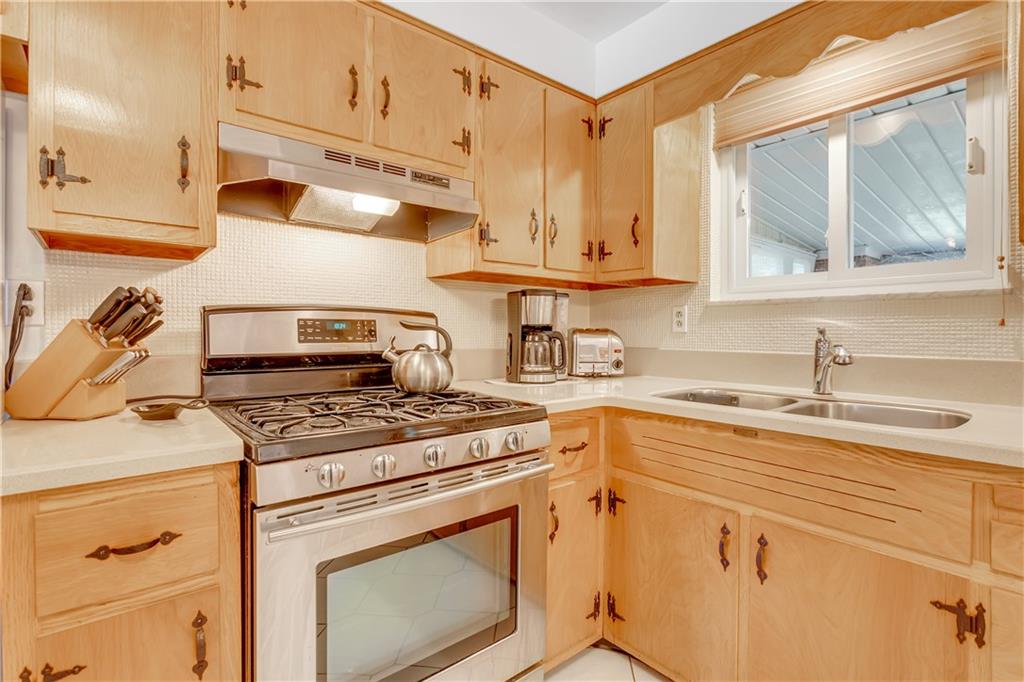 207 Erwin Place McKees Rocks, PA 15136 - Photo 10 of 25 Corian counters, tile backsplash and pristine original maple cabinetry.