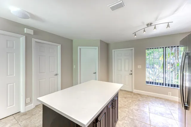 a spacious bedroom with a bed and a window