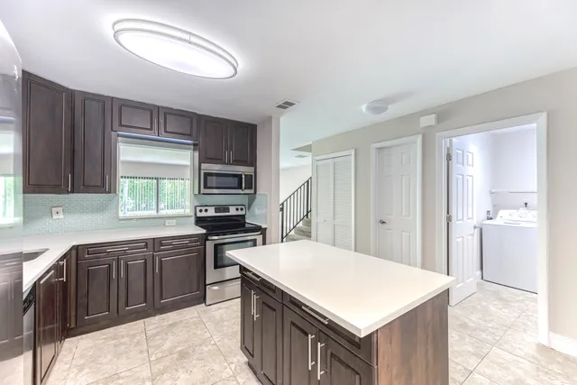 a kitchen with a stove a sink and a refrigerator