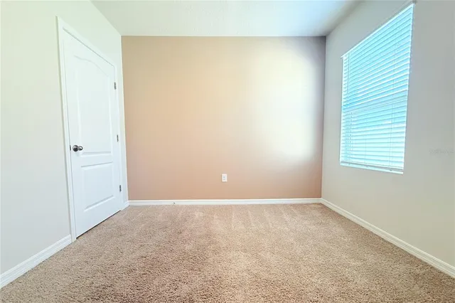a view of a kitchen cabinets a sink and a refrigerator in a room