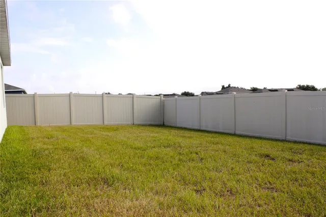 an aerial view of residential houses with outdoor space and city view