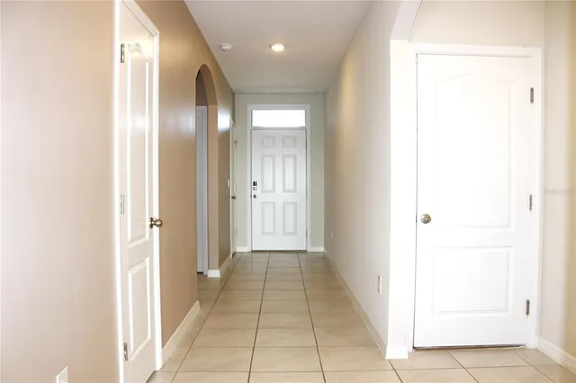 a view of a hallway with closet and a bathroom
