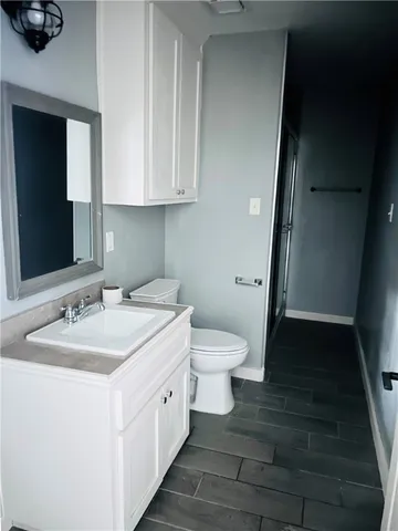 a spacious bathroom with a toilet sink and mirror