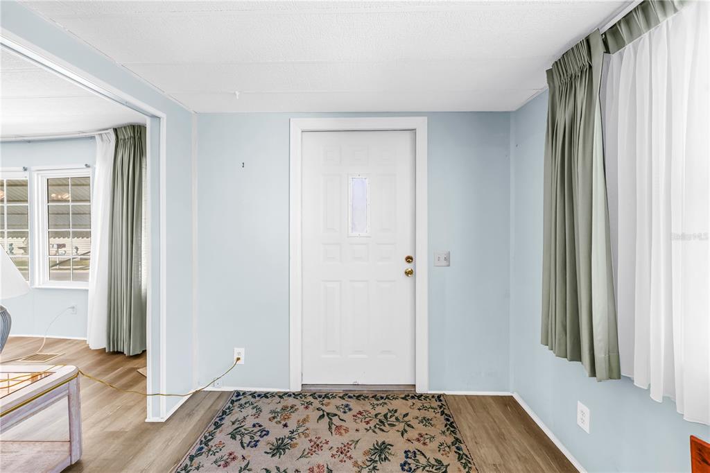 1100 South Belcher Road, Unit 502 Largo, FL 33771 - Photo 3 of 51 a bedroom with a bed and wooden floor