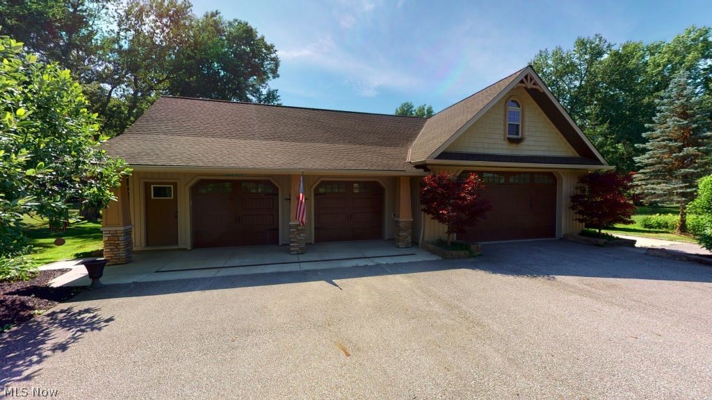 6556 Stone Road Hudson, OH 44236 - Photo 35 of 35 Custom built barn with space to park an RV or Large boat tucked away on the right hand side. Back garage door makes it very easy to access lawn equipment, golf cart or recreational toys.