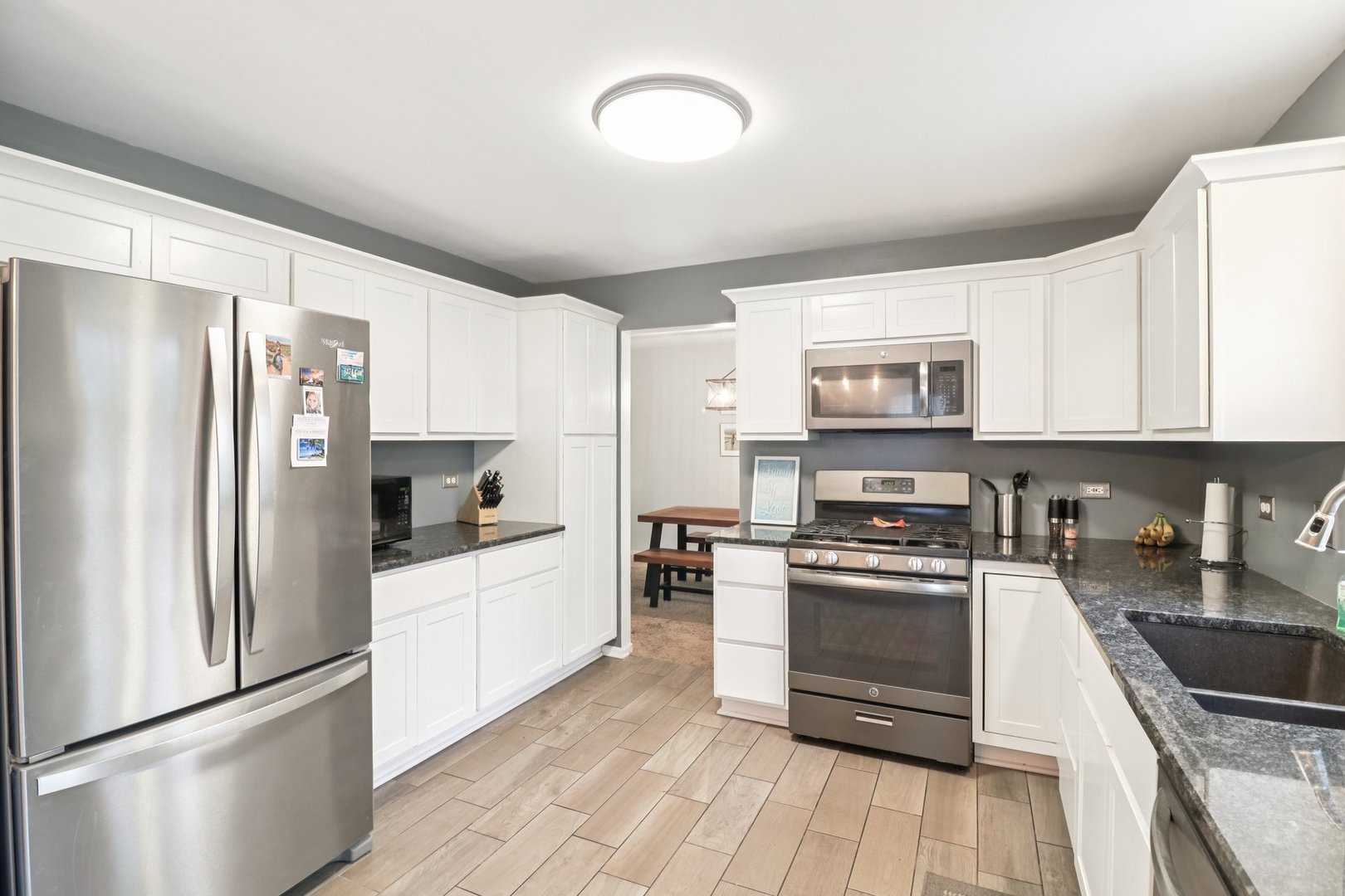 1256 Edgewater Lane Antioch, IL 60002 - Photo 11 of 45 a kitchen with granite countertop a refrigerator stove and microwave