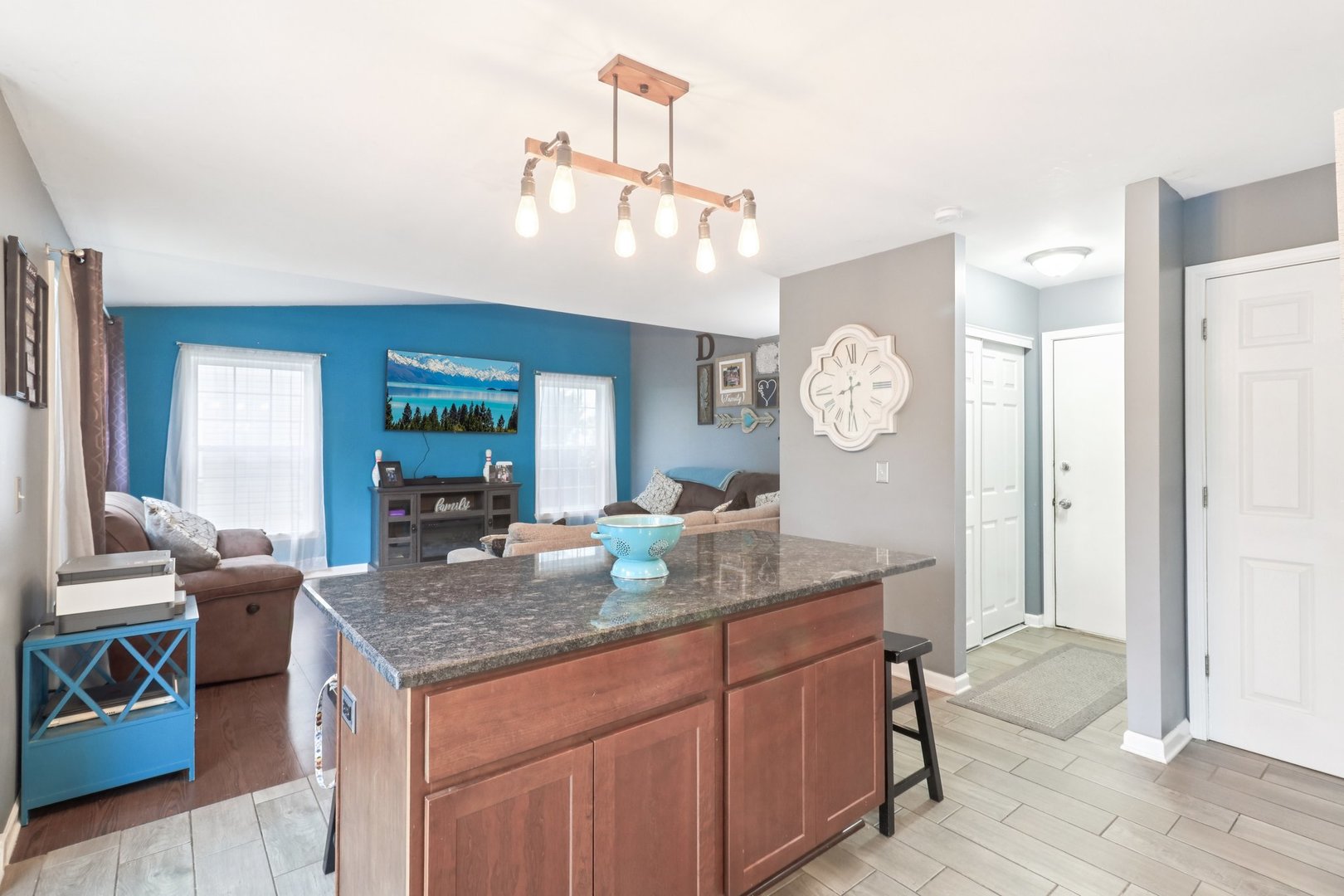 1256 Edgewater Lane Antioch, IL 60002 - Photo 13 of 45 a hall with kitchen island granite countertop furniture and a chandelier