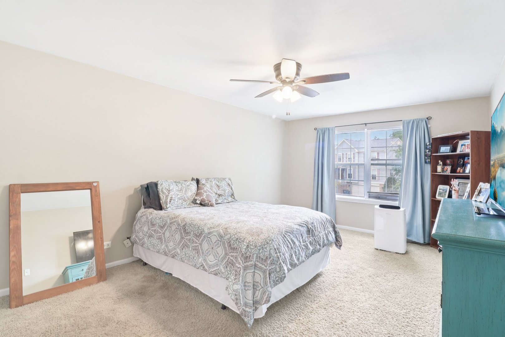 1256 Edgewater Lane Antioch, IL 60002 - Photo 19 of 45 a bedroom with a large bed and a chandelier