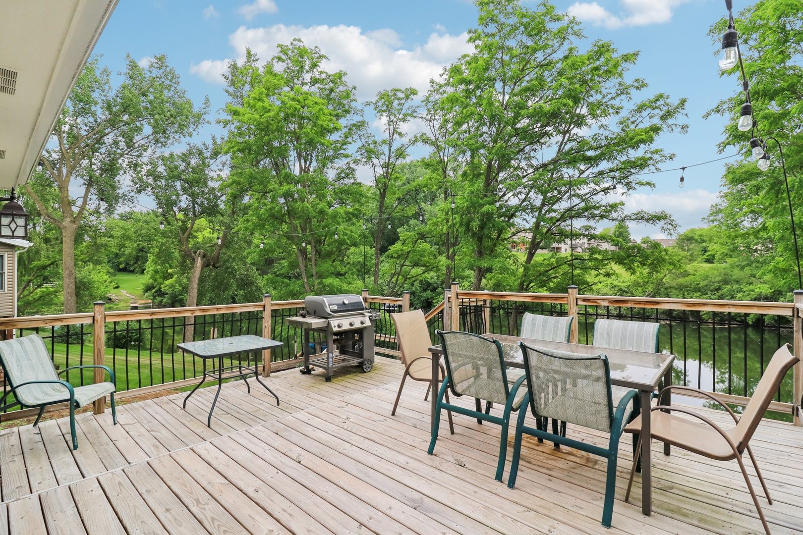 1256 Edgewater Lane Antioch, IL 60002 - Photo 39 of 45 a view of a roof deck with table and chairs with wooden floor and fence