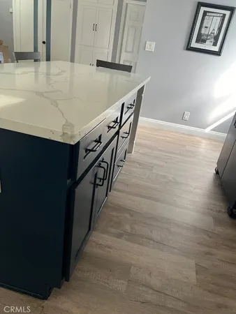 a bed sitting in a bedroom next to a wooden cabinet